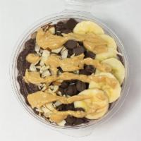 Nutty Chocolate Acai Bowl · Organic Açaí topped with Banana, Chocolate Chips, Almonds and a drizzle of Peanut Butter Sauce