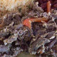 Costilla De Cerdo Frita · Fried pork ribs with rice and salad 
Acompañado: arroz amarillo y ensalada