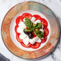 Caprese · Fresh mozzarella, vine ripened tomatoes, roasted peppers, and basil.