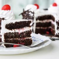 Black Forest Cake · Chocolate sponge cake with layers of cherry jam and whipped cream topped with a creamy choco...
