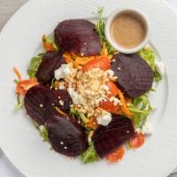 Beet Salad · Beets over arugula, toasted pinenuts, and goat cheese.