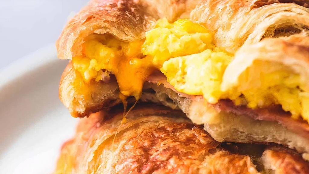 Breakfast Croissant  · Scrambled eggs, bacon & cheddar on a croissant.