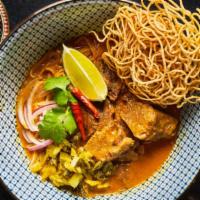 Khao Soi Neua (Beef) · Northern Thai style steamed egg noodles with khao soi curry, slow cooked beef, red onions, f...