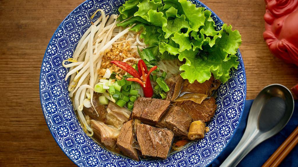 Beef Noodle Soup · Double braised beef shank in an infused Chinese herbs & spices broth, leaf lettuce, bean sprouts, cilantro and rice noodles. Served with house made hot sauce.