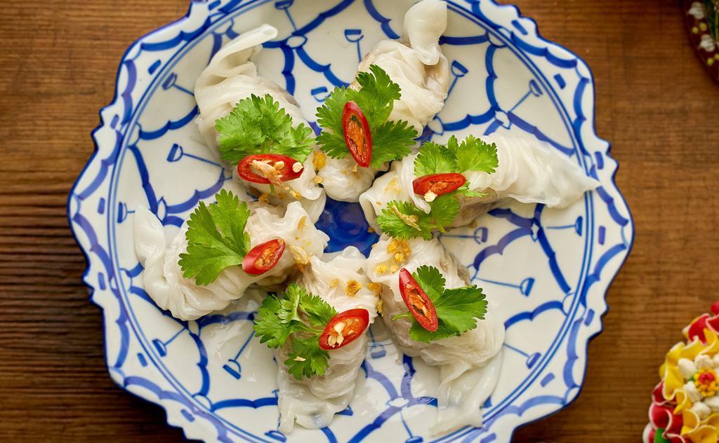 Pak Mor Cashew (4Pcs) · Vegan, Gluten Free. Dumplings made with sauté grounded cashew nuts, sweet radish, shallot, cilantro and coconut sugar filled in freshly steamed rice paper. Served with sea salted coconut sauce.