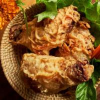Kai Tod · Southern Thai style fried chicken topped with crispy shallot rings. Served with a sweet chil...