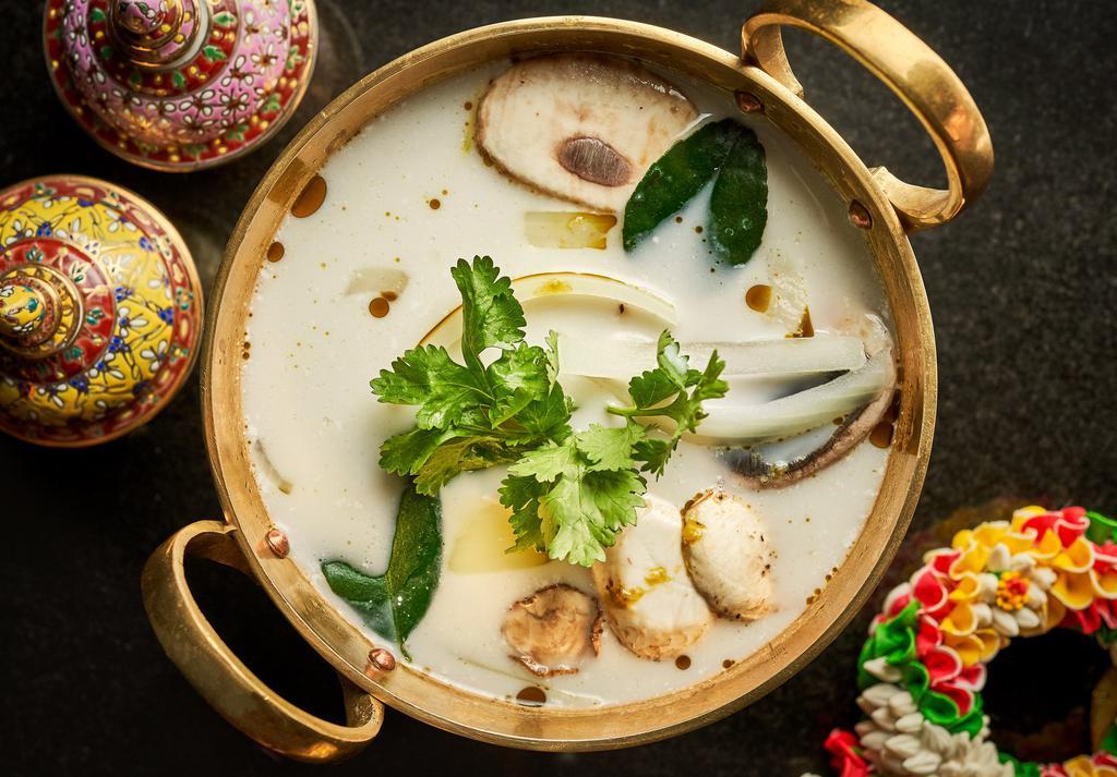 Tom Kha Soup (Large) · Gluten Free. Classic coconut soup infused with lemon grass, galangals, kaffir lime leaves with onions, mushrooms and cilantro chive oil.