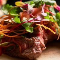 Yum Beef · Gluten-Free. Grilled flank steak, fresh herbs, smoked chili paste, tamarind juice and toaste...