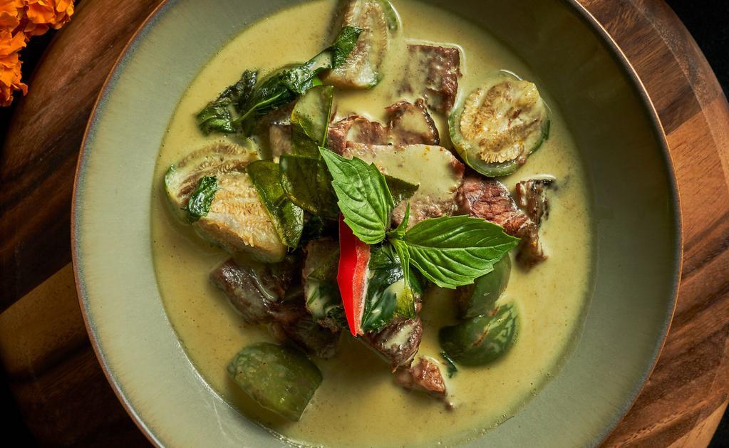 Green Curry · Gluten Free. Spicy Item. Grandma’s recipe. Green curry with Thai eggplant, coconut milk, bell pepper,  bamboo shoots and fresh Thai basil. Served with jasmine rice.