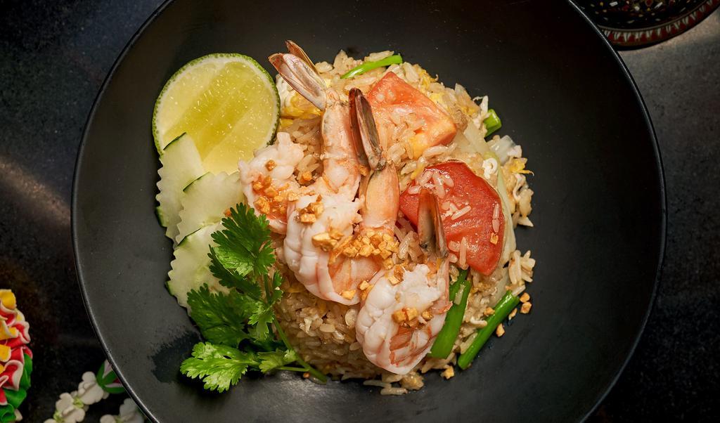 Thai Fried Rice · Thai style fried rice with egg, onions, scallions and tomatoes.