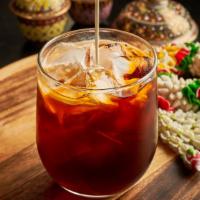 Thai Iced Tea · Strongly-brewed spiced black tea, sweetened with sugar and milk served over ice.