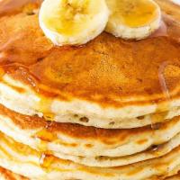 Banana Pancakes · Three fluffy banana pancakes with maple syrup and butter.