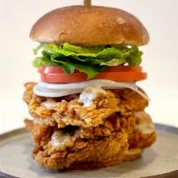 Deluxe Thigh Burger / 디럭스 싸이버거 · A massive chicken burger, with double crispy-fried boneless thighs, lettuce, onions, tomatoe...