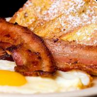 Dandy Breakfast French Toast · Delicious French toast cooked to perfection and served with Ham, Bacon, Sausage, Two cooked ...