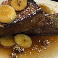 Banana Foster (Stuffed French Toast) · Sliced Bananas drizzled in Foster Sauce and sandwiched between two slices of French Toast.