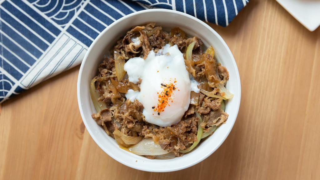 Gyudon · Thinly sliced beef simmered with tender onions, housemade sweet and savory sauce for 5+ hours and topped with an poached egg over white rice.