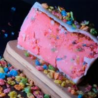 White Chocolate Dipped Frozen Fruity Pebbles Cheesecake · A cheesecake baked to perfection infused with fruity pebbles, perfectly frozen and dipped in...