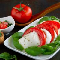 Insalata Neapolitana Salad · Freshly prepared salad topped with Fresh mozzarella cheese, roasted peppers, and sun dried t...