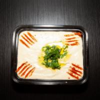 Hummus · Chickpeas, tahini, lemon, garlic, and olive oil, served with pita.