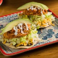 Tinga Tostada · Crispy Tortilla, Chicken, Romaine, Pico De Gallo, Avocado, Cotija Cheese, and Cream.