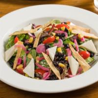 Crispy Tortilla Salad · Fresh Romaine, Corn, Black Bean, Cherry Tomatoes, Queso Fresco, Red Onion, Avocado, and Hous...