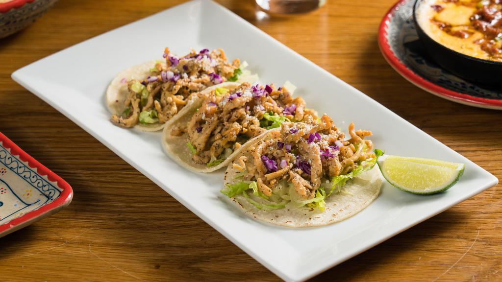 Tacos De Pollo · Chicken, Romaine Lettuce, Red Cabbage, Cotija Cheese, and Lemon Dressing.