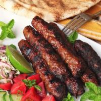 Lamb Seekh Kabab · Sliced lamb marinated in herbs and spices. Cooked in a clay oven.