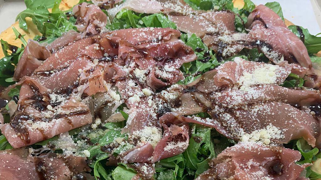Parma · Chopped tomatoes, basil and EVOO, topped with arugula and imported prosciutto di Parma.