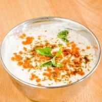 Raita · Refreshing yogurt with cucumber, carrots, and spices.