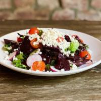 Beet Salad · Roasted beets and goat cheese over a bed of mixed greens tossed in our house mustard vinaigr...