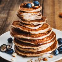 Berry Nut Pancakes · Delicious fluffy pancakes with fresh blueberries topped with almonds.