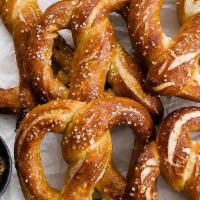 Soft Pretzel · Bavarian-style hot soft pretzel served with mustard and vegan cheese dip.