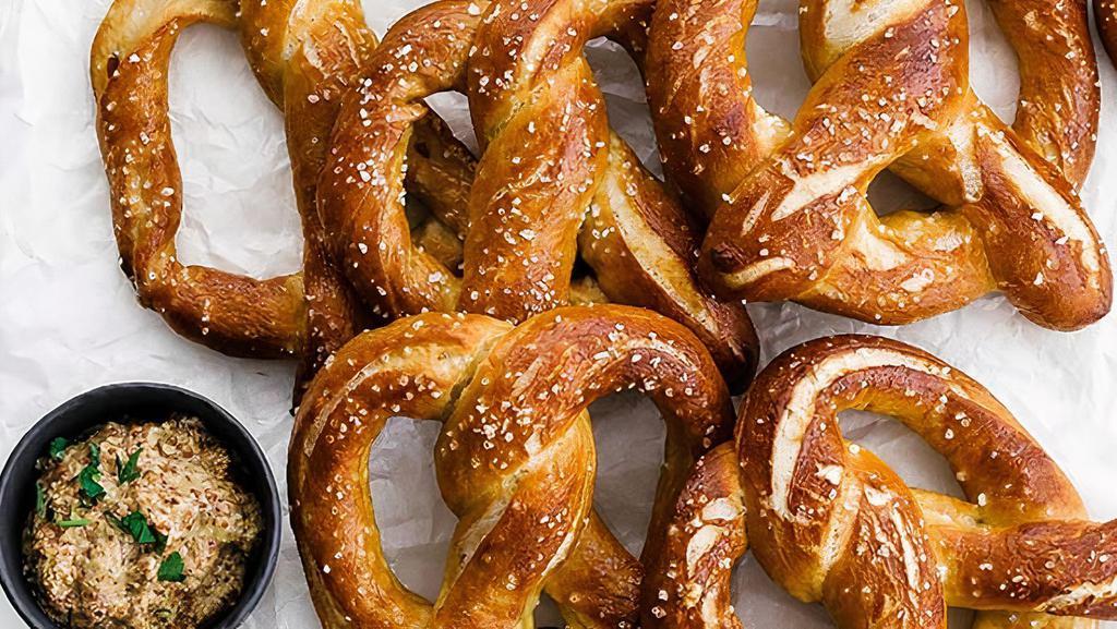 Soft Pretzel · Bavarian-style hot soft pretzel served with mustard and vegan cheese dip.