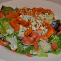 Buffalo Chicken Salad · Fresh mixed greens tossed in ranch dressing, topped with buffalo chicken strips, tomatoes, a...