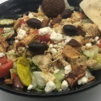 Greek Chicken Salad · Lettuce topped with chicken, tomatoes, feta cheese and kalamata olives, pita croutons served...