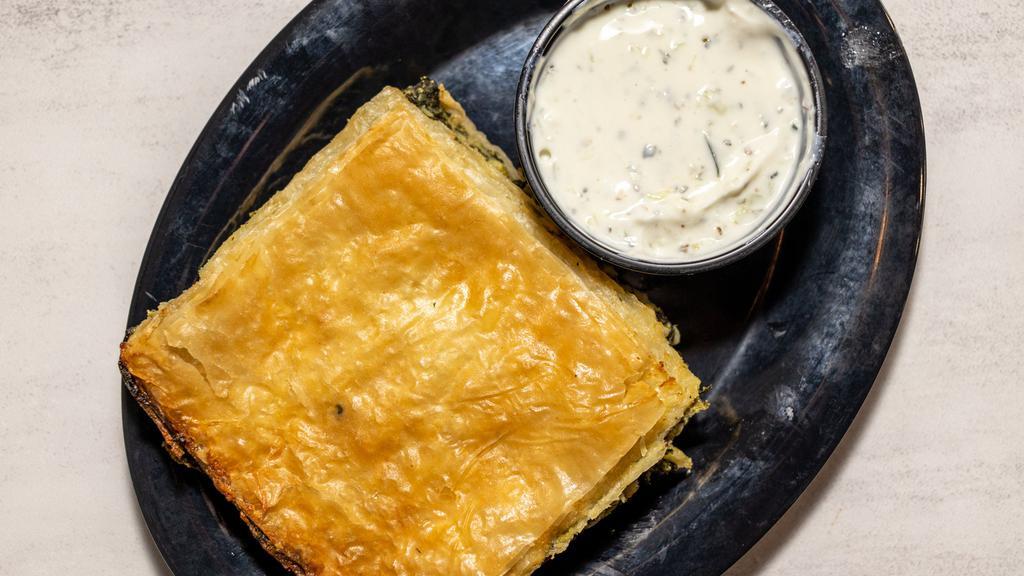 Spanakopita Combo · Vegetarian. Feta cheese and spinach pie, nestled in layers of filo dough and baked until golden, served with tzatziki and house salad.