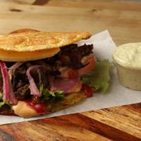 Steak Patacon · Green Platain Sandwich allied With Grilled steak, grilled Cheese, lettuce, tomatoes, pink sa...