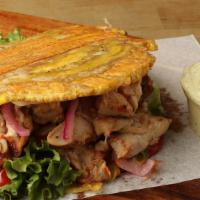 Grilled Chicken Patacon · Green Plantain Sandwich allied With Grilled Chicken, grilled Cheese, lettuce, tomatoes, pink...