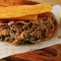 Pernil Patacones · Roasted pork. A sandwich made with slices of twice fried green plantains instead of bread, w...