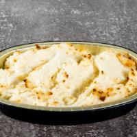 Garlic Mashed Potatoes · Potatoes, milk, cream, butter, spices, and garlic.