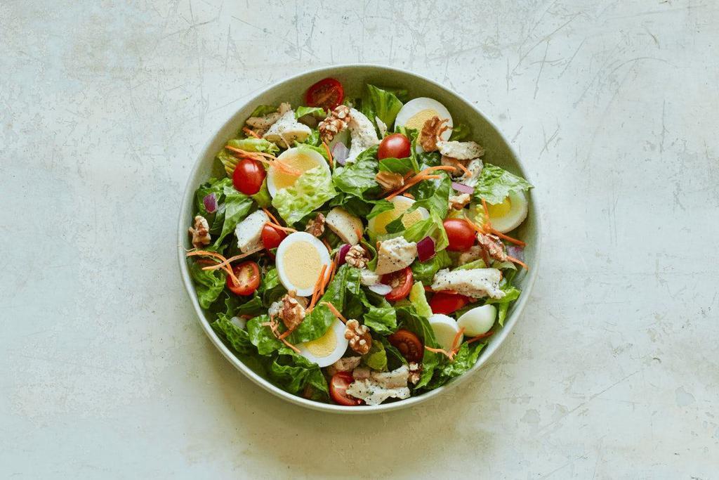 High Protein Salad (Gf) · Olive oil + balsamic vinegar, chopped romaine, roasted chicken, double hard-boiled egg, grape tomatoes, red onions, carrots, and roasted walnuts