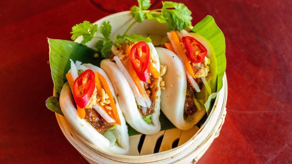 Bao Buns · Braised pork belly, pickled carrot, pickled daikon and shredded pickled cabbage, garnished with cilantro and crushed peanuts. (3 pieces)