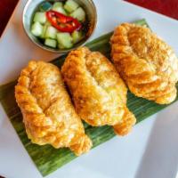 Curry Puffs · Pastries stuffed with potato, carrot, peas, corn and curry powder, served with a cucumber re...