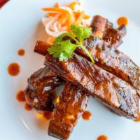 Tuk Tuk Ribs · Fried pork ribs marinated in hoisin sauce, Thai spices and herbs, garnished with shredded dr...