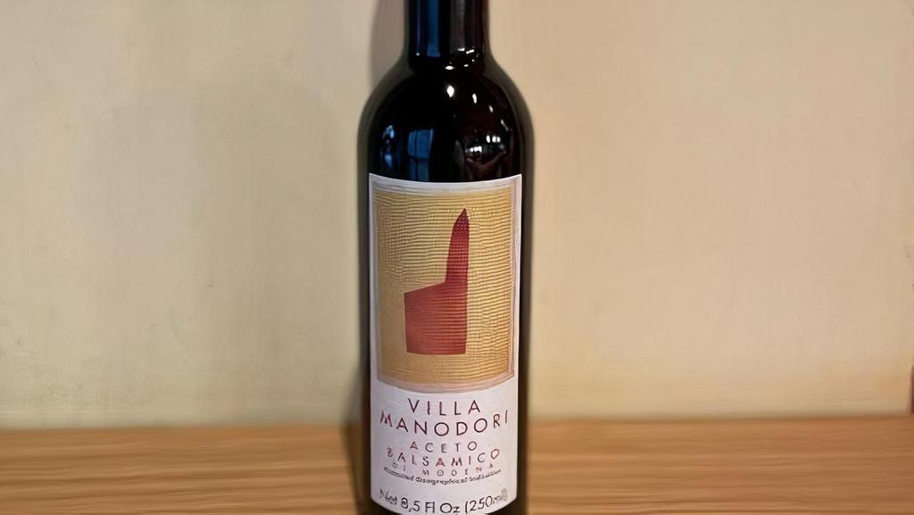 Villa Manodori Artigianale Balsamico · Villa Manodori Balsamic vinegar is the labor of Massimo Bottura, Chef Patron of the three Michelin star restaurant Osteria Francescana in Modena, Italy. He produces this artisanal balsamic vinegar in very limited quantities. Villa Manodori begins with locally grown grapes, which are reduced into must, and then aged in different wood barrels. Villa Manodori's dark color and rich aroma reflect a century of family tradition. Aceto Balsamico perfectly glazes steak, pork and poultry. Add it to sauce or drizzle it over risotto or sliced Parmigiano-Reggiano cheese. Toss greens such as arugula and radicchio with aceto balsamico, then add a swirl of Villa Manodori Extra Virgin Olive Oil and a pinch of salt. For dessert, try fresh berries sprinkled with powdered sugar and Villa Manodori aceto balsamico.
