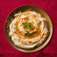 Hummus Appetizer · A blend of chickpeas  with tahini, garlic, and lemon juice, topped with olive oil.