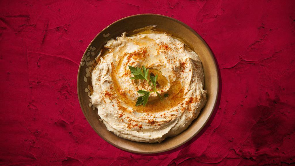 Hummus Appetizer · A blend of chickpeas  with tahini, garlic, and lemon juice, topped with olive oil.