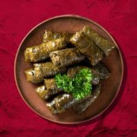 Dolma Destiny · Fresh grape leaves are stuffed with Stuffed with vegetables, rice, herbs & spices served ove...