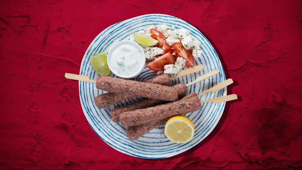 Kefta Plate Forever · Classic kafta kabob recipe of ground beef and lamb with onion, parsley, and spices served with house rice, steamed fresh mixed vegetables and salad