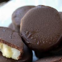 Frozen Banana Slices · Frozen banana slices dipped in dark chocolate! Half pound bag contains 10 - 12 slices. Keep ...